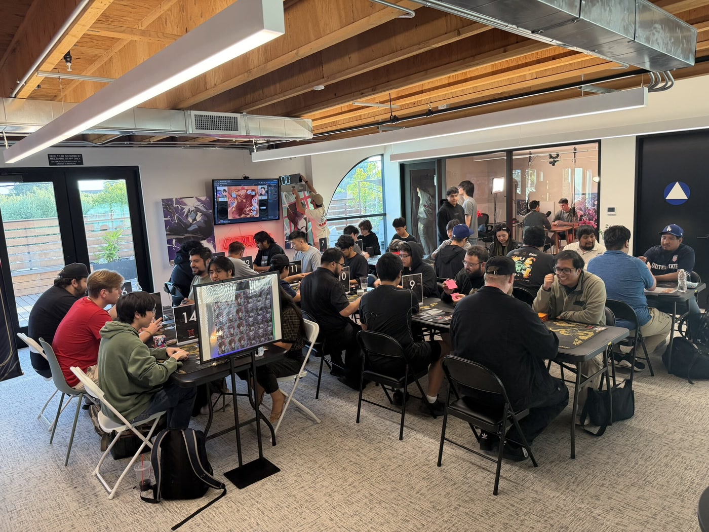 Players competing in an Azuki TCG event at a local card shop.